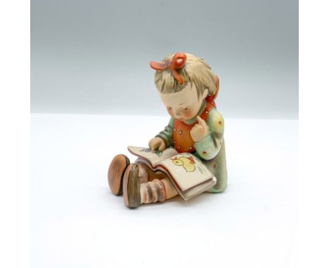 Hand-painted figurine depicting a young girl looking at a picture book. TMK-3 Goebel backstamp on the bottom. Issued: 1960'sD