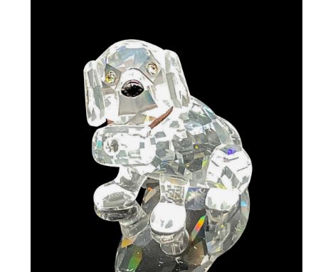 Clear faceted figure with tawny crystal eyes, black nose, and elastic collar holding a keg. Swarovski backstamp.7619 000 006.