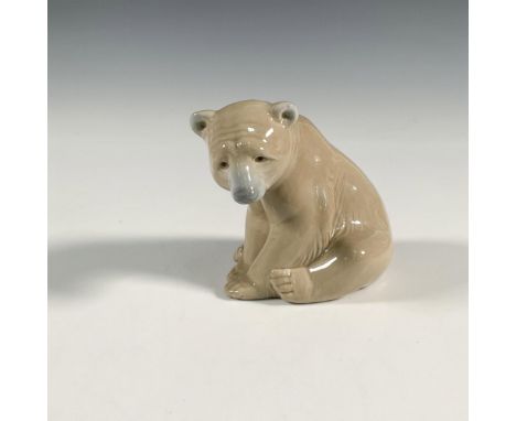 A glossy figure of a brown bear. Lladro backstamp. This item has its original box: 7.75"L x 5"W x 3.75"H Artist: Juan HuertaI