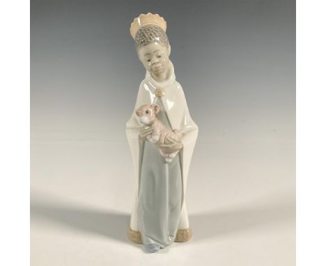 A glossy figure of a young boy dressed as a king holding a pink teddy bear. Lladro backstamp. This item has a box: 10.25"L x 