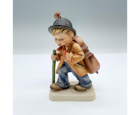 Hand-painted figurine depicting a boy with a walking stick and large cello on his back. TMK-6 Goebel backstamp on the bottom.