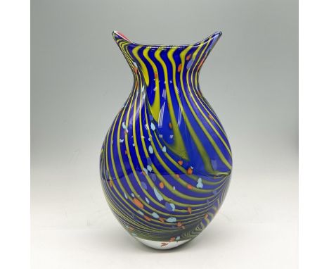 Multicolored cased glass with a base of royal blue with yellow swirls and accents of orange and lighter blue. Interior red gl