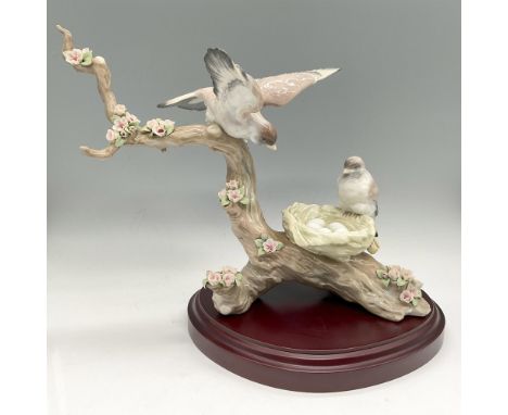 Lovely, glazed art piece depicting birds on branch and nest admiring their 5 eggs. Colored in brown, white, and green with pi
