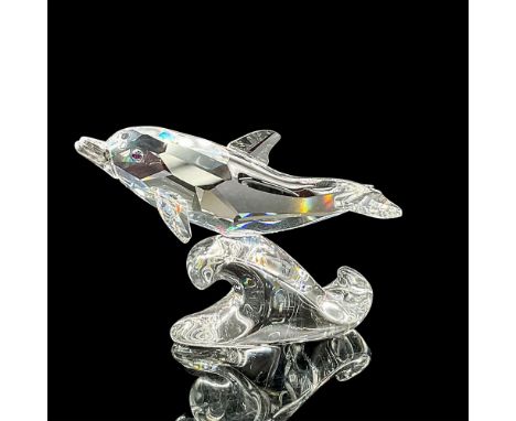 Faceted crystal figure of a happy little dolphin riding a wave. Swarovski mark. Item number 678507. This item has its origina