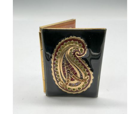 Enameled in emerald-green with a raised gilt metal paisley design that has Swarovski crystals integrated into the design. Amb