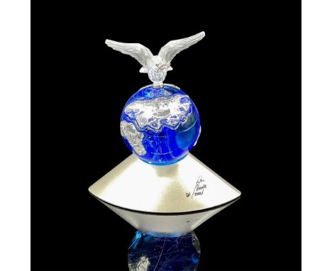 Designed in blue crystal set on silver base, reflects continents in clear crystal with peace dove, wings spread on top with o