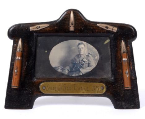 GREAT WAR - SOUVENIR FROM FRANCE 1919 - A TRENCH ART WOODEN TABLE PHOTOGRAPH FRAME  decorated with brass cartridge cases, bul