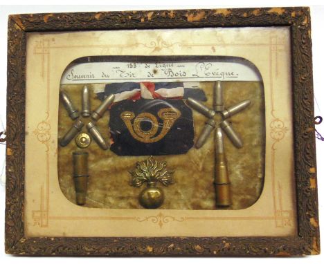 GREAT WAR - A COLLECTION OF FRENCH INSIGNIA AND INERT AMMUNITION  mounted for display, labelled '153 eme. de Ligne - Souvenir