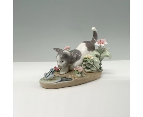 Glossy finish. A white and gray kitten perched down curious about the frog in front of him. Lladro backstamp. This item has i