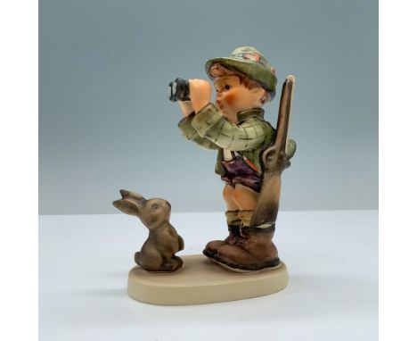 Hand painted porcelain with matte finish. Depicts an explorer-hunter boy in green clothes with a rabbit. Goebel backstamp. M.