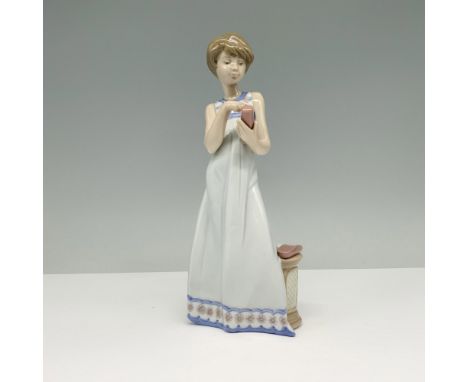 Glossy finish modeled as a young girl using a telephone. Lladro backstamp. This item has its original box. Box measures: 11.2