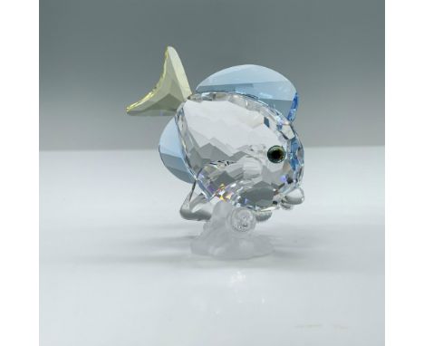 A clear crystal fish that is accented with blue and yellow crystal in a downwards swimming position. Swarovski swan mark. 886