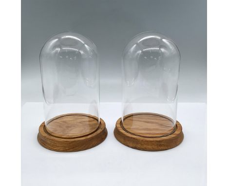 Two glass domes fitted into golden walnut stained wooden bases. Each measures 7.75"H x 5.25"dia. Issued: 21st centuryDimensio