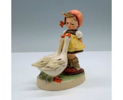 Hand painted porcelain depicts a little girl dressed in an apron and polka-dot kerchief, leaning back with flowers hidden beh