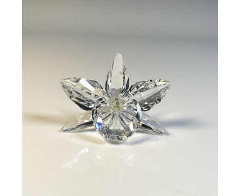 Elegant clear crystal figure featuring an orchid with a dark yellow center. Swarovski swan mark. This item includes a cushion
