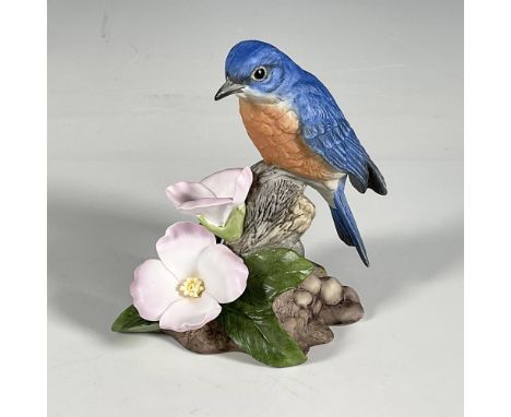 Created as a 40th anniversary issue, this vintage porcelain bluebird sits atop a tree stump above 2 pink roses. The colors us