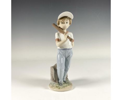 Glossy figure of an adorable boy with a baseball on his shoulder, adorned in serene color tones. Lladro backstamp. This item 