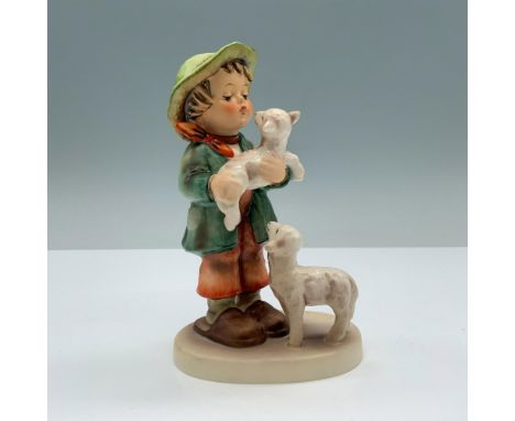 Hand painted porcelain features a little boy with two lambs. Goebel backstamp. M. I. Hummel impressed on the round base. Dime
