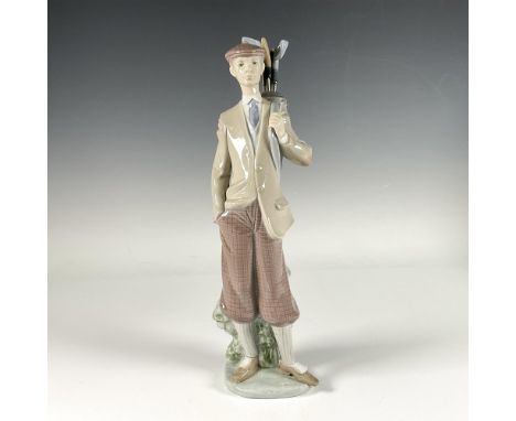 Glossy porcelain figure of a young golfer in elegant attire, holding a golf club and preparing to take a swing. Lladro backst