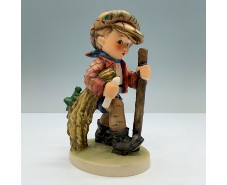 Hand painted in matte finish modeled as a young boy walking on a path with a walking stick. M. I. Hummel impressed backstamp.