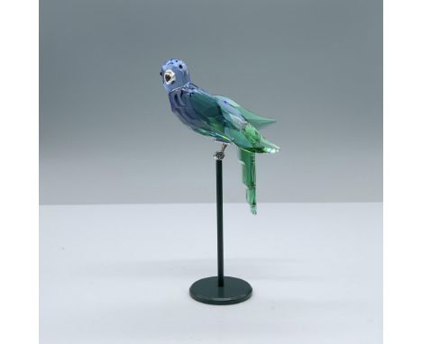 Depicts a parrot made of blue and green crystal. Black crystal and silver colored metal are used for the accents. Swarovski s