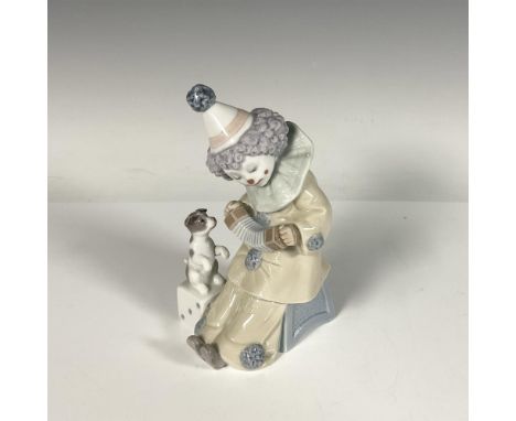 Glossy porcelain figure of a child clown playing an accordion, while a dog appreciates the concert. Lladro backstamp. Artist: