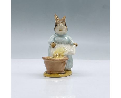 Glossy porcelain. Features a rabbit with a blue dress and apron. Beswick Beatrix Potter backstamp. This item has its original