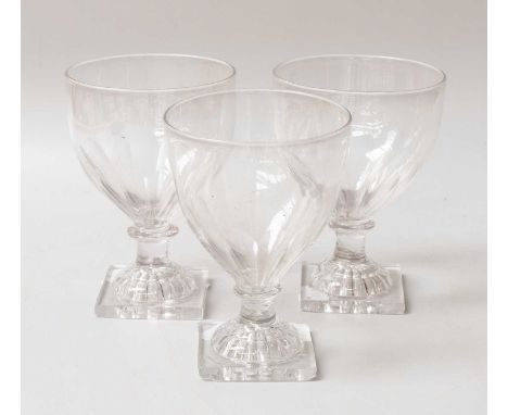 A Set of Three George III Rummers, partially fluted bowls, with knopped stems and on 'lemon squeezer' bases, 13cm (3)One rumm