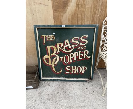 A VINTAGE WOODEN 'THE BRASS AND COPPER SHOP' SIGN 