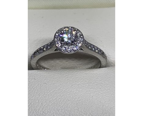 A PLATINUM AND DIAMOND HALO RING SIZE M/N IN A PRESENTATION BOX 