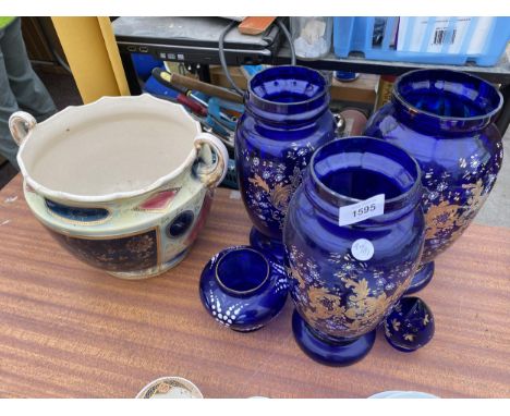 A GROUP OF THREE LARGE BLUE GLASS VASES AND A CERAMIC PLANTER 