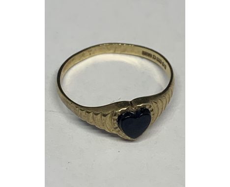 A 9 CARAT GOLD RING WITH A BLACK HEART SHAPED STONE SIZE L/M IN A PRESENTATION BOX 