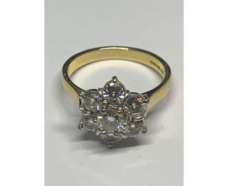 AN 18 CARAT GOLD RING WITH SEVEN MANUFACTURED DIAMONDS IN A FLOWER DESIGN SIZE M IN A PRESENTATION BOX 