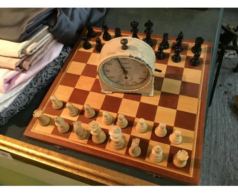 A WOODEN CHESS SET AND CHESS PIECES AND A CHESS TIMER CLOCK IN WORKING ORDER AT TIME OF LOTTING 