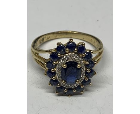A 9 CARAT GOLD CLUSTER RING WITH A CENTRE SAPPHIRE AND SURROUNDING DIAMONDS AND SAPPHIRES SIZE 0 