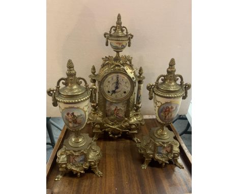 A DECORATIVE MANTLE CLOCK WITH A COURTING COUPLE DESIGN, GARNITURES AND KEY 
