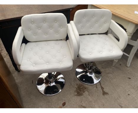 A PAIR OF WHITE BUTTON-BACK ADJUSTABLE STOOL ARMCHAIRS ON CHROME BASES 