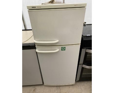 A WHITE BOSCH CLASSIX UPRIGHT FRIDGE FREEZER WITH INSTRUCTION MANUAL 