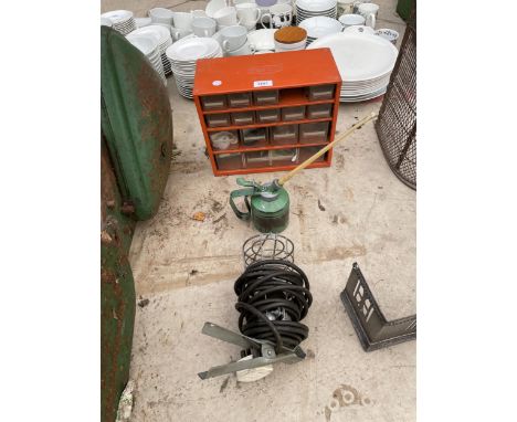A RAACO STORAGE UNIT, AN OIL CAN AND AN INSPECTION LAMP 