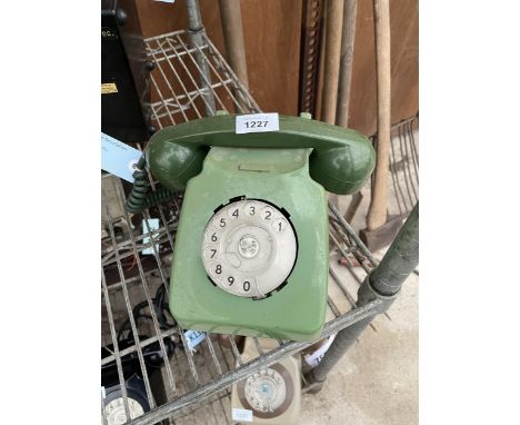 A RETRO GREEN ROTARY DIAL TELEPHONE 