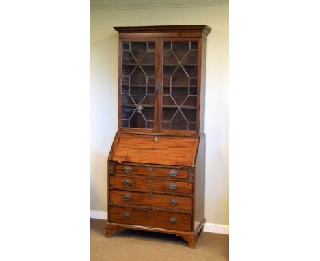 George III mahogany bureau and associated book case, the upper stage having a moulded dentil cornice over pair of thirteen pa