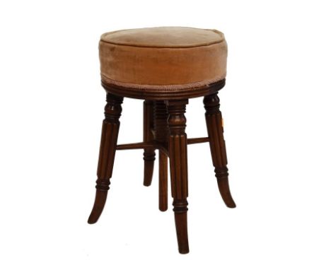 19th Century mahogany revolving music stool, the stuffed circular top upholstered in pink dralon, standing on splayed turned 