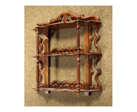 Early 20th Century mahogany wall bracket fitted three shelves supported by slender turned and reeded pilasters   Condition: 