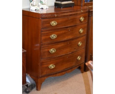 George III mahogany bowfront chest, the top with ebonised banding, fitted brushing slide with four long graduated drawers bel