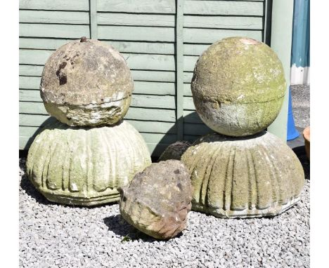 Large pair of reconstituted stone gate post finials, each of stacking ball design, together with a pineapple gate post finial