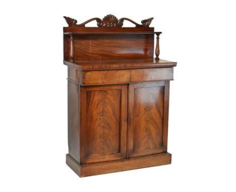 William IV mahogany chiffonier, the raised back with carved pediment, single shelf supported by turned pillars, the base fitt