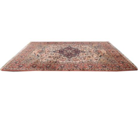 Middle Eastern style carpet decorated with a central medallion on a beige ground within multi borders   Condition: 