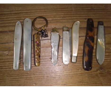 A collection of 8 penknives to include 4 silver and mother of pearl, etc. 