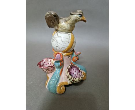 An early 19th century Staffordshire pottery inkwell modelled as an eagle perched on a globe above a mythical dolphin and shel