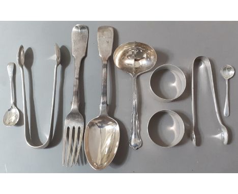 A mixed lot of silver items including, a strainer ladle, two napkin rings, spoon, fork, tongs, etc. Gross wt. 8ozt. 